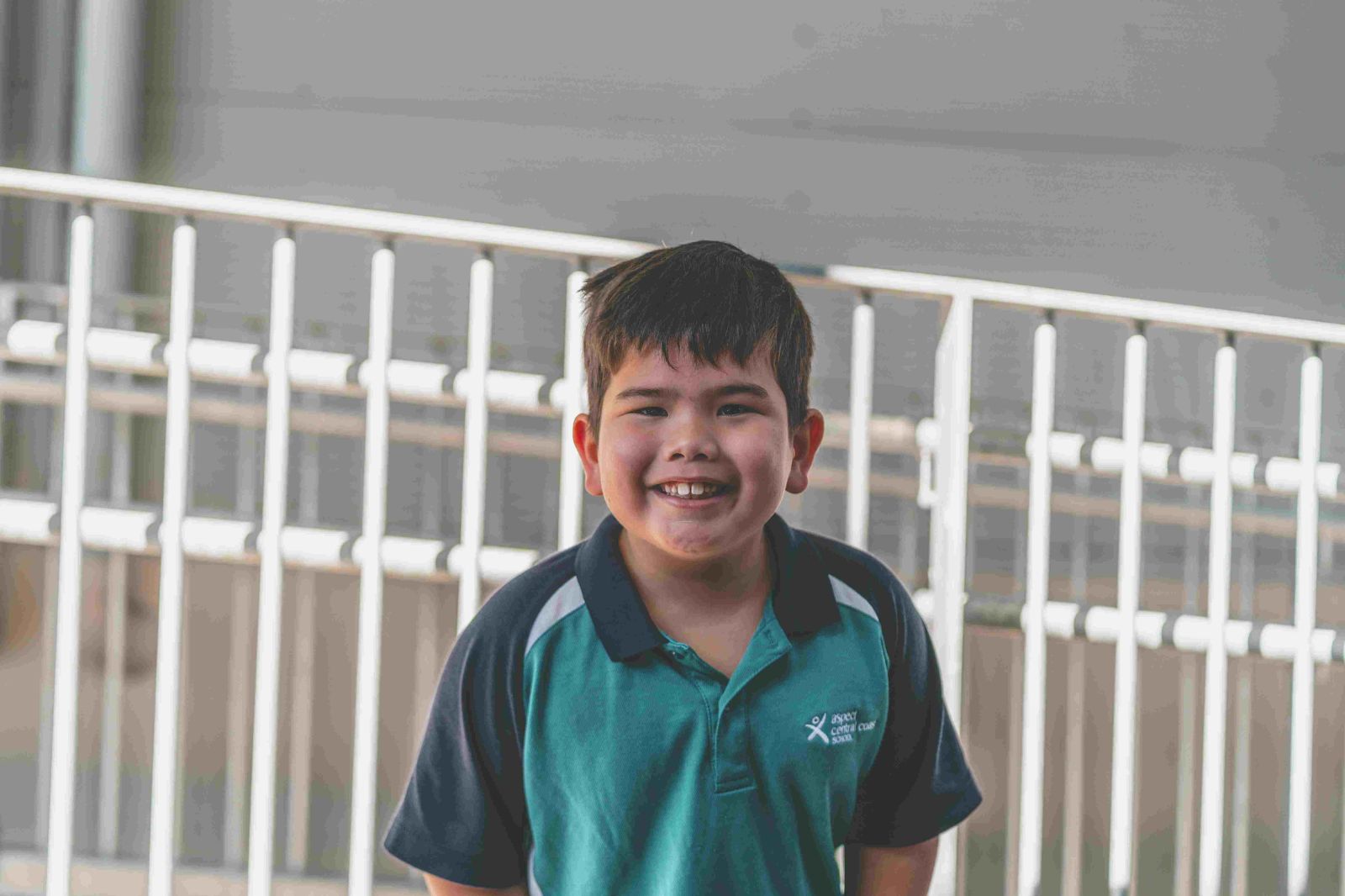 Student smiling confidently in school environment